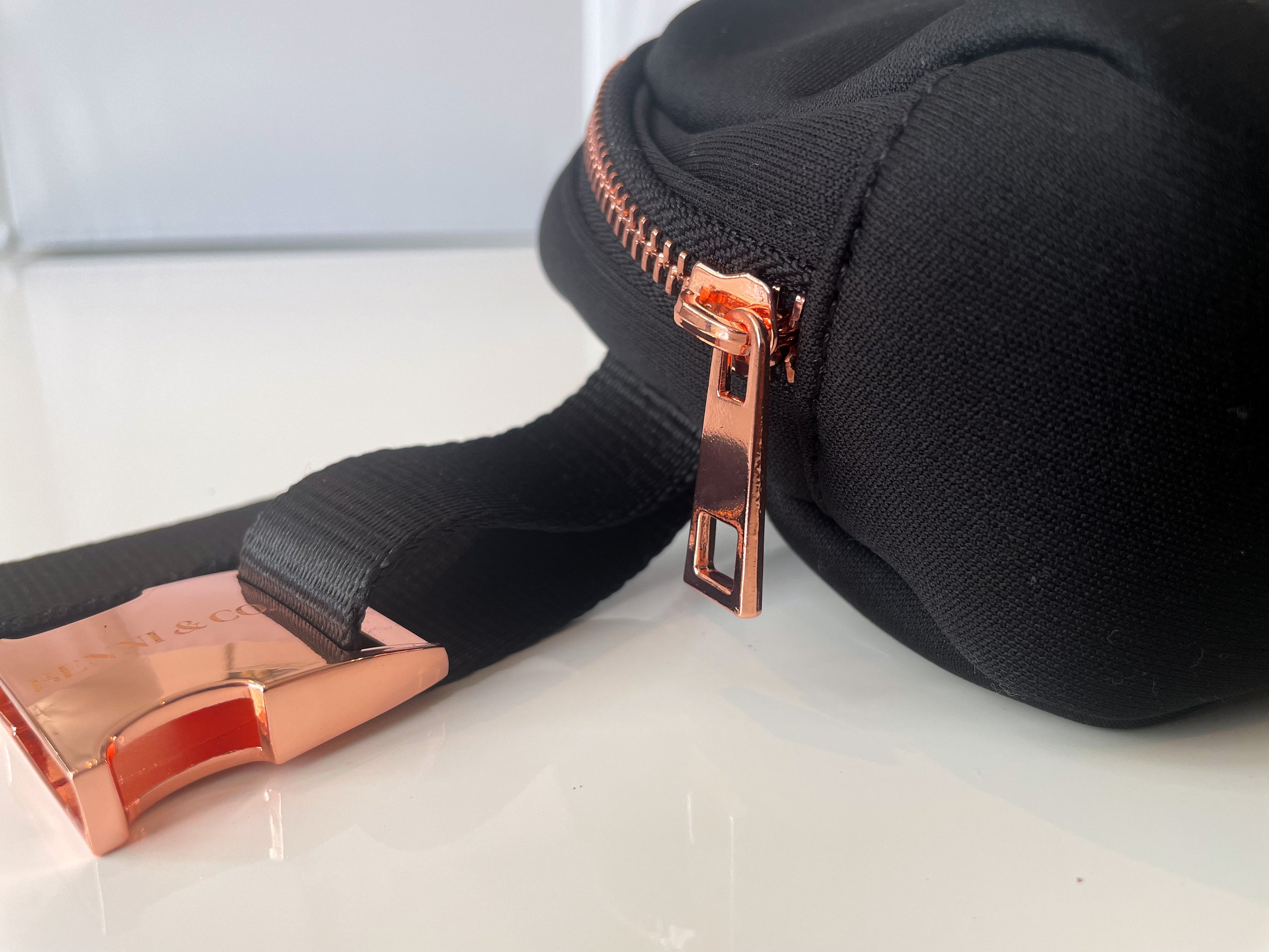 A stylish New Black Walkies Bag designed for dog parents, featuring rose gold hardware and adjustable straps.